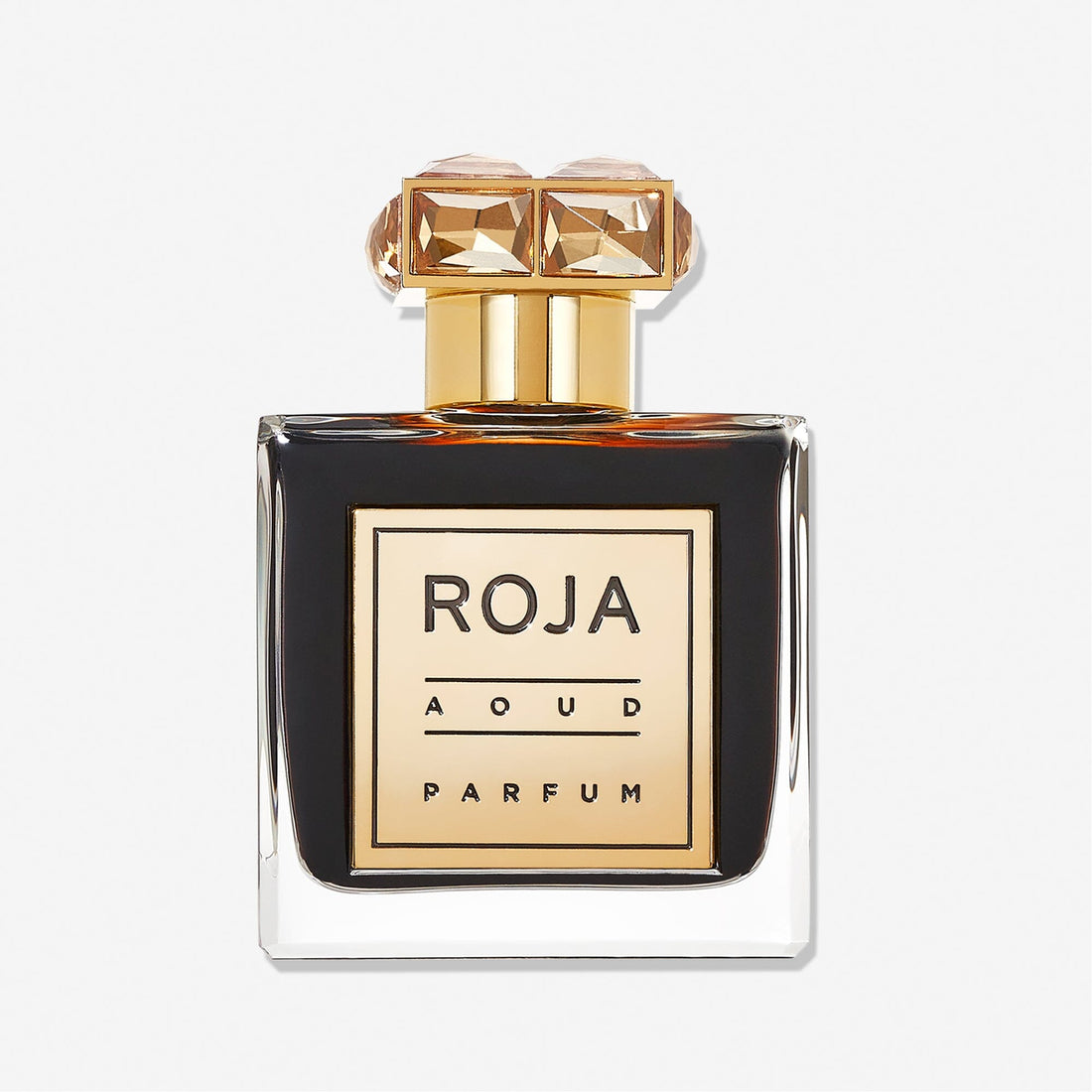 A square glass bottle with dark liquid, a gold cap topped with gem-like accents, and a label reading Roja Parfums Aoud presents this luxurious Oud Wood fragrance against a plain white background.