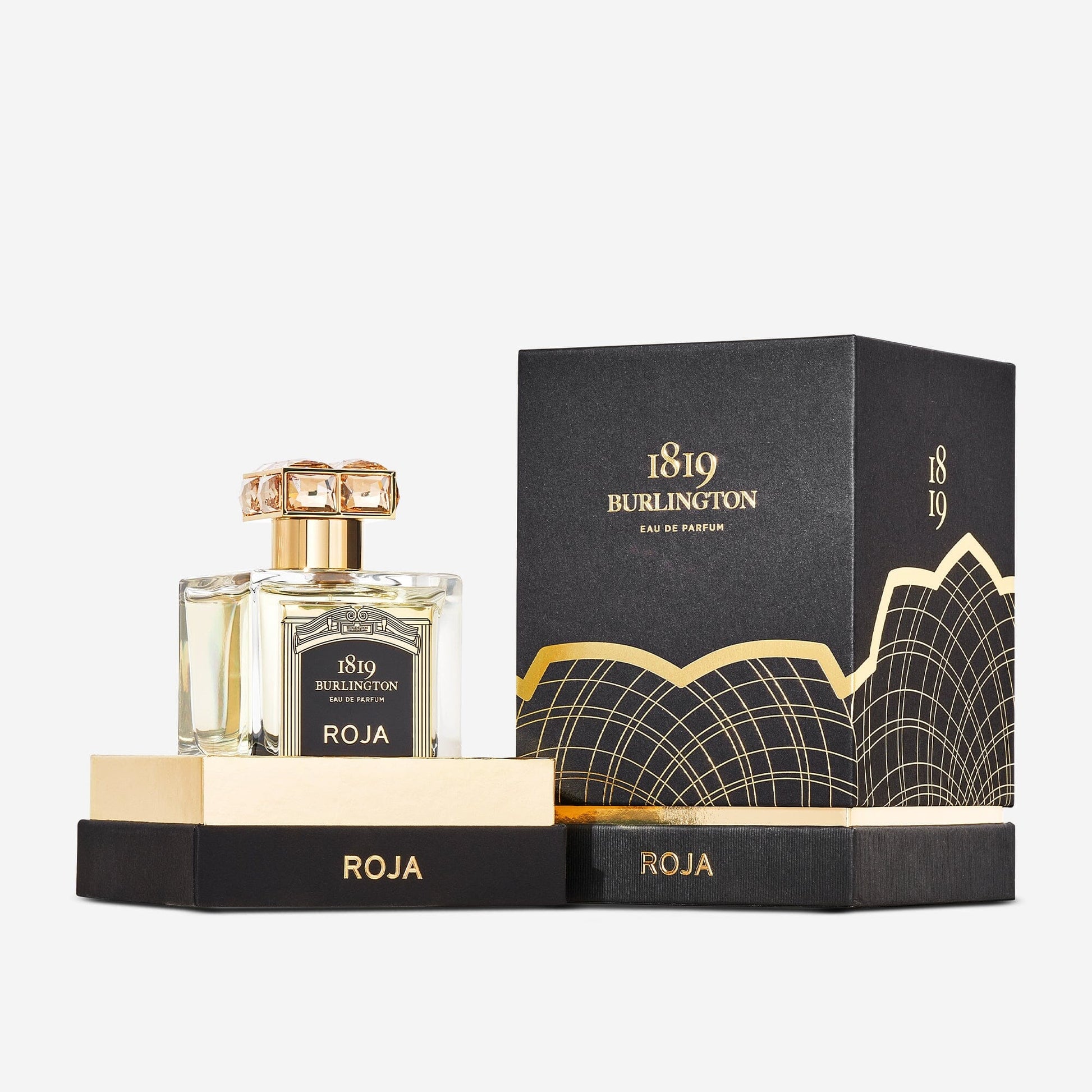 A glass bottle of Burlington 1819 Eau de Parfum by Roja Parfums sits in an open black and gold box, with the matching perfume box behind—showcasing the luxury found at ROJA Parfums in Burlington Arcade.