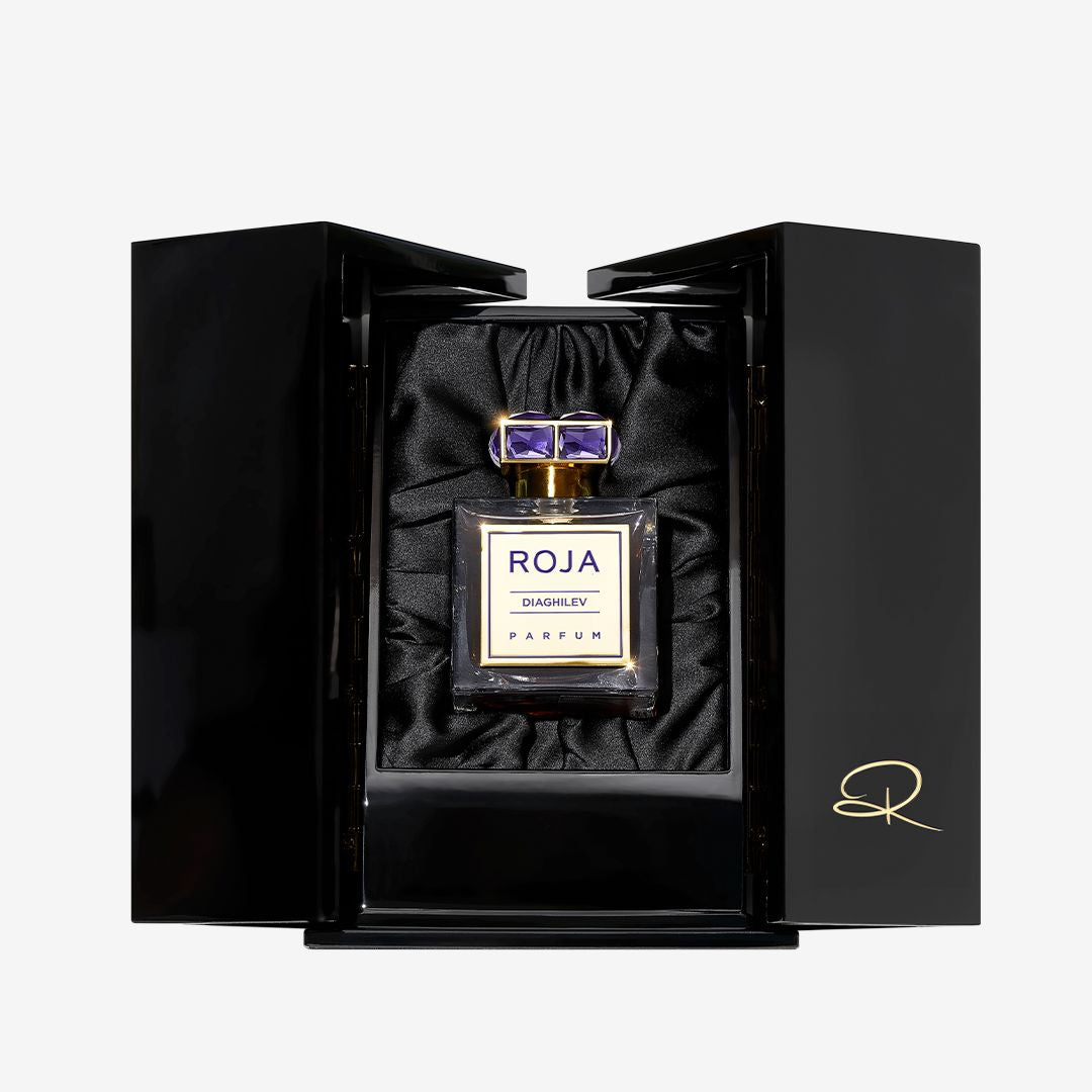 Roja Parfums Diaghilev, an iconic Chypré perfume, rests in a black satin-lined box with gold accents and a signed door—luxury and artistry captured in each bottle.