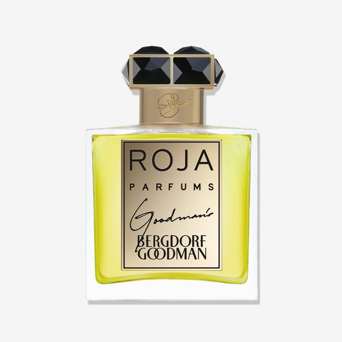 A bottle of Roja Parfums Goodmans fragrance showcases a yellow liquid, a gold label with black lettering, and a faceted black-and-gold cap. The label features the Chypré accord with the Roja Parfums and Goodmans names.