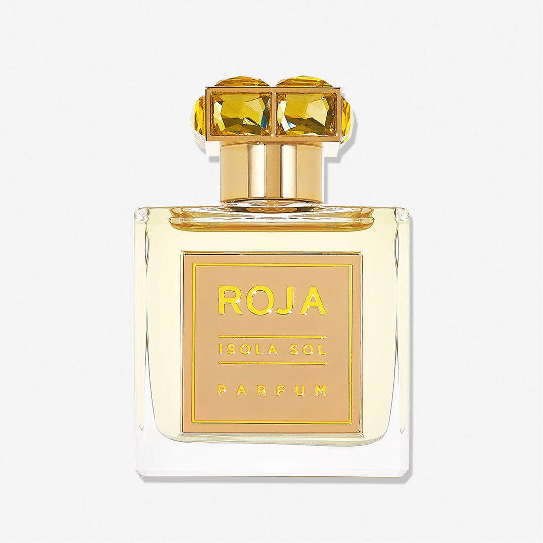 A clear glass perfume bottle labeled Isola Sol by Roja Parfums, topped with a gold cap featuring two large yellow gemstones, evokes island vacation vibes against a plain white background.
