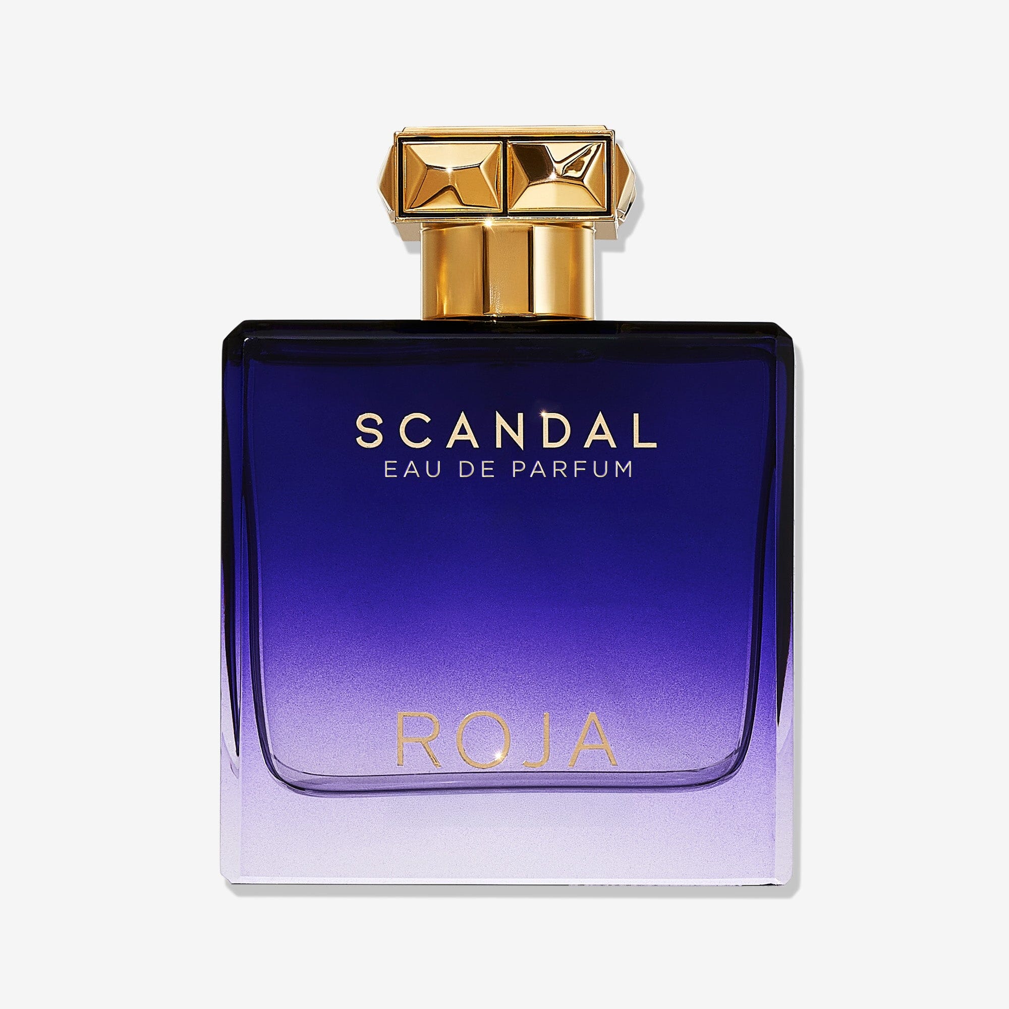 A rectangular perfume bottle with a gold cap features a gradient from deep purple to light lavender, gold Scandal Pour Homme lettering, and holds ROJA Parfums modern Fougère cologne for men.