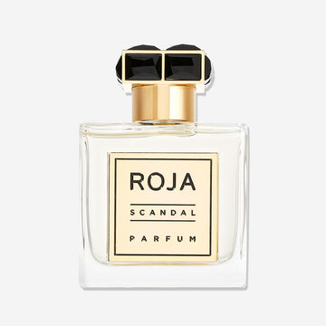A clear glass bottle of Scandal Pour Homme by Roja Parfums, featuring a gold and black rectangular cap and a gold front label—an elegant choice for the modern gentleman who appreciates a refined Fougère fragrance.