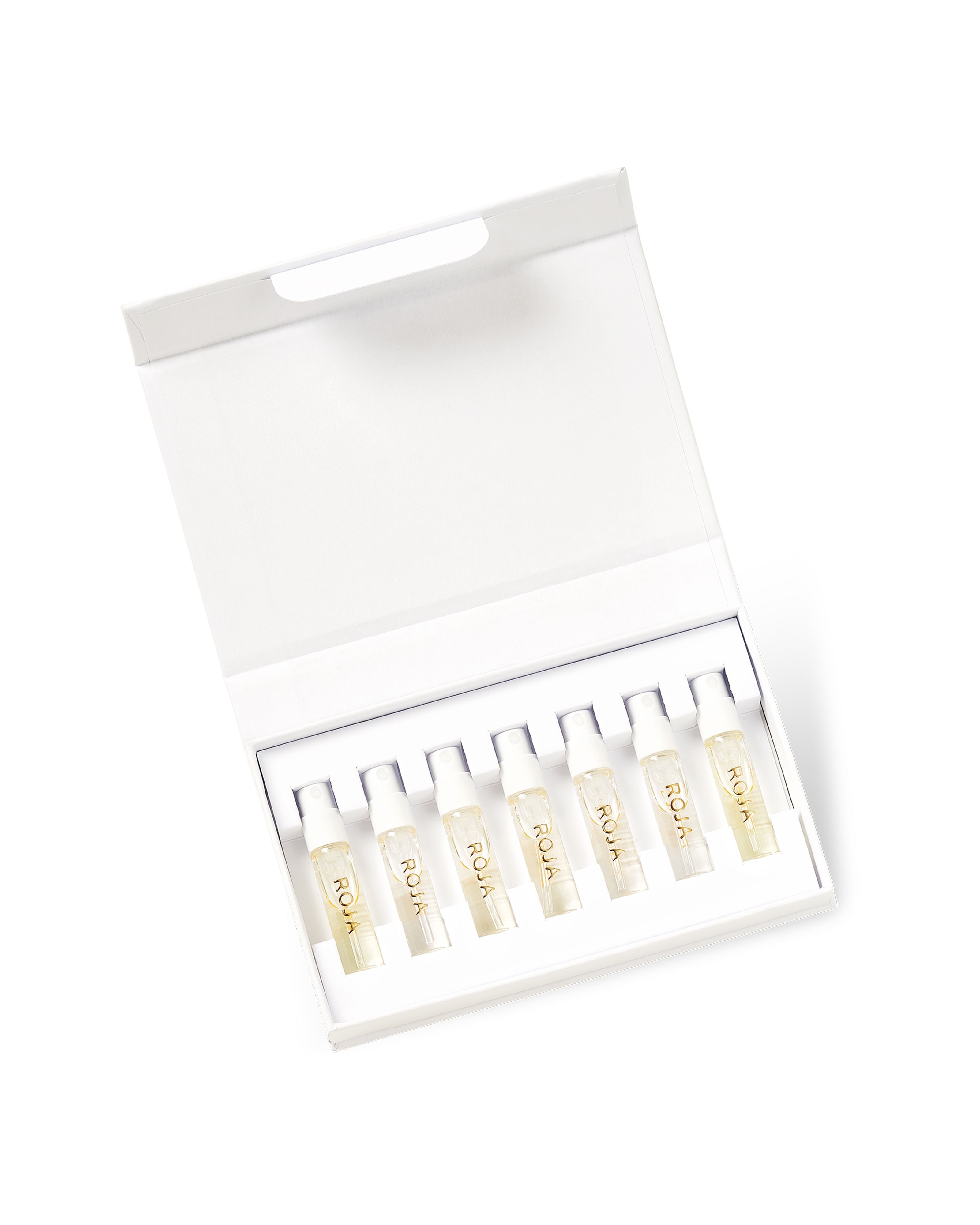An open white box from Roja Parfums, The Womens Discovery Collection, holds eight white ampoules neatly arranged in a row with an empty upper compartment, evoking the elegance of luxury perfume collections.