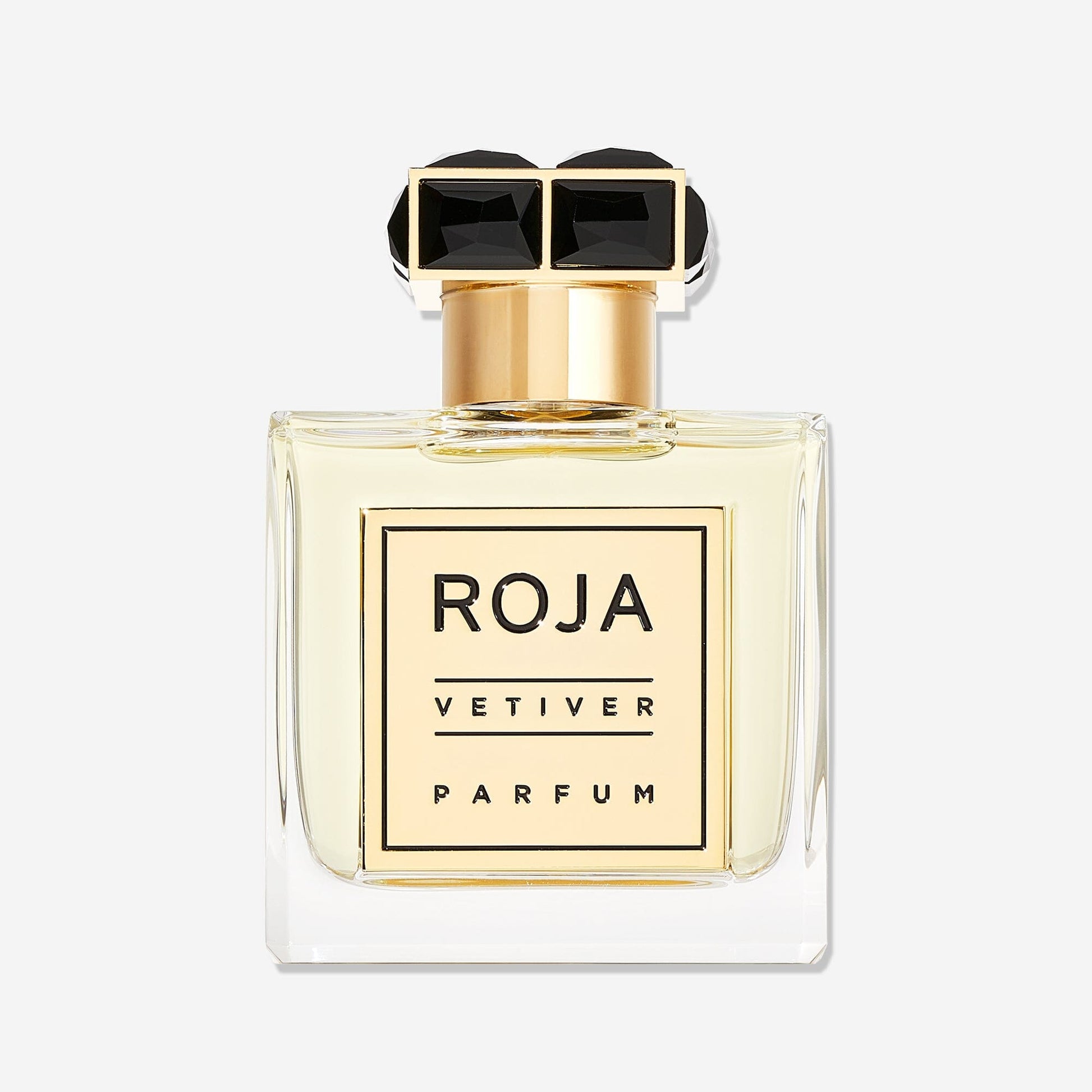 A clear glass bottle with pale yellow liquid, a gold label reading VETIVER POUR HOMME, and a gold cap with two black jewels defines this elegant Roja Parfums design, hinting at a classic vetiver scent for men.