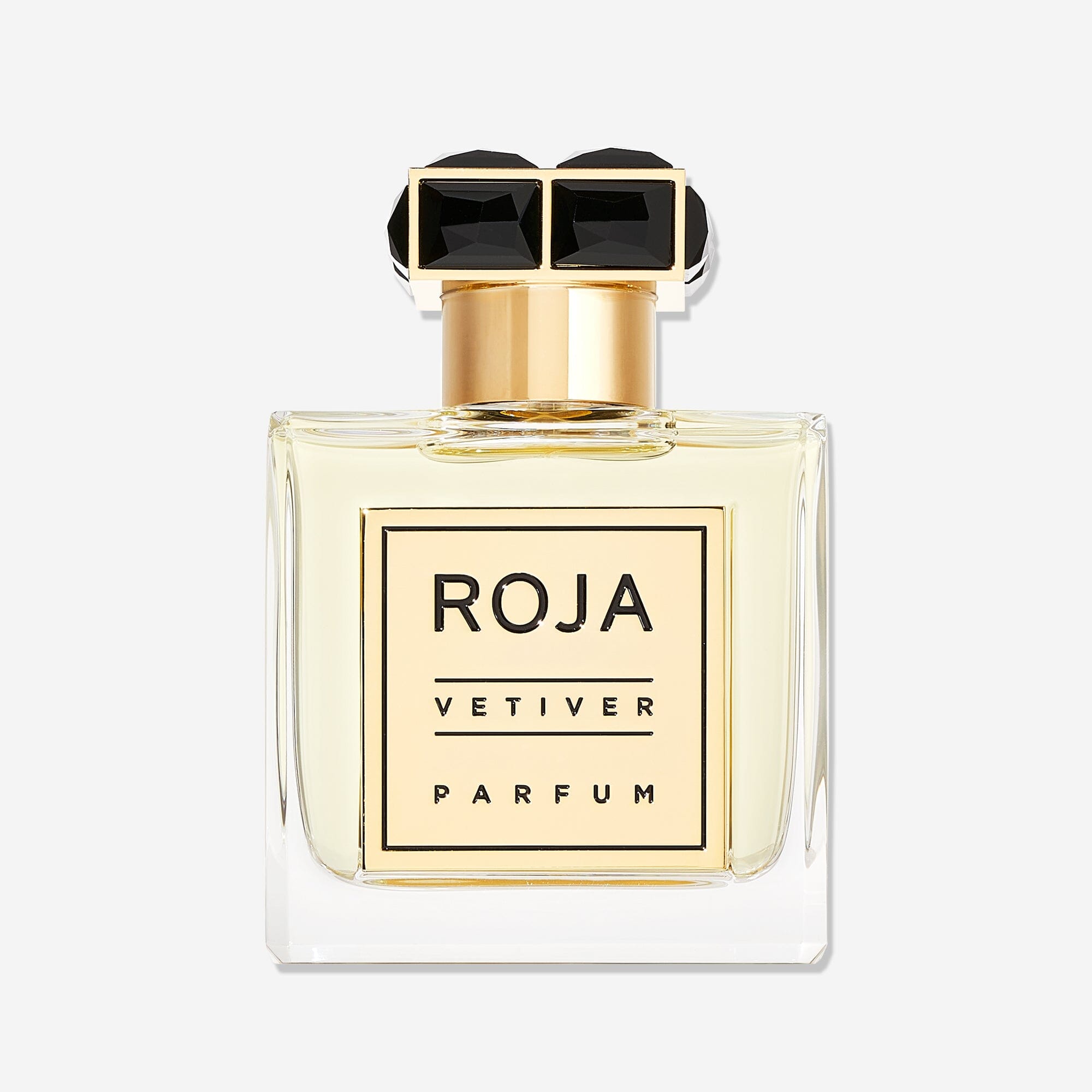 A clear glass bottle with pale yellow liquid, a gold label reading VETIVER POUR HOMME, and a gold cap with two black jewels defines this elegant Roja Parfums design, hinting at a classic vetiver scent for men.