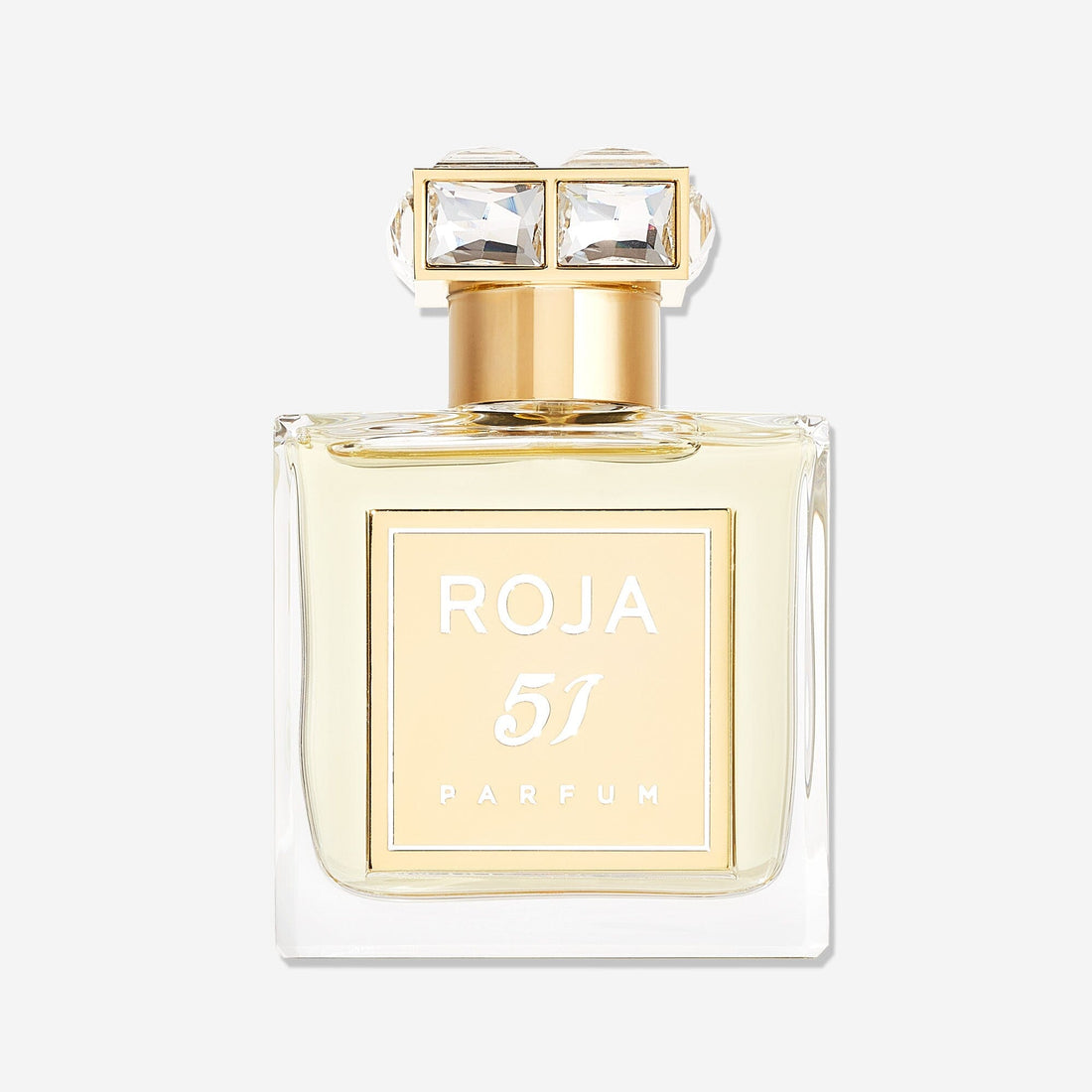 A clear glass bottle of Roja Parfums 51 Pour Femme, a luxury fragrance, features a gold label and cap with two square gem-like accents. The bottle contains pale yellow liquid and is displayed against a plain white background.