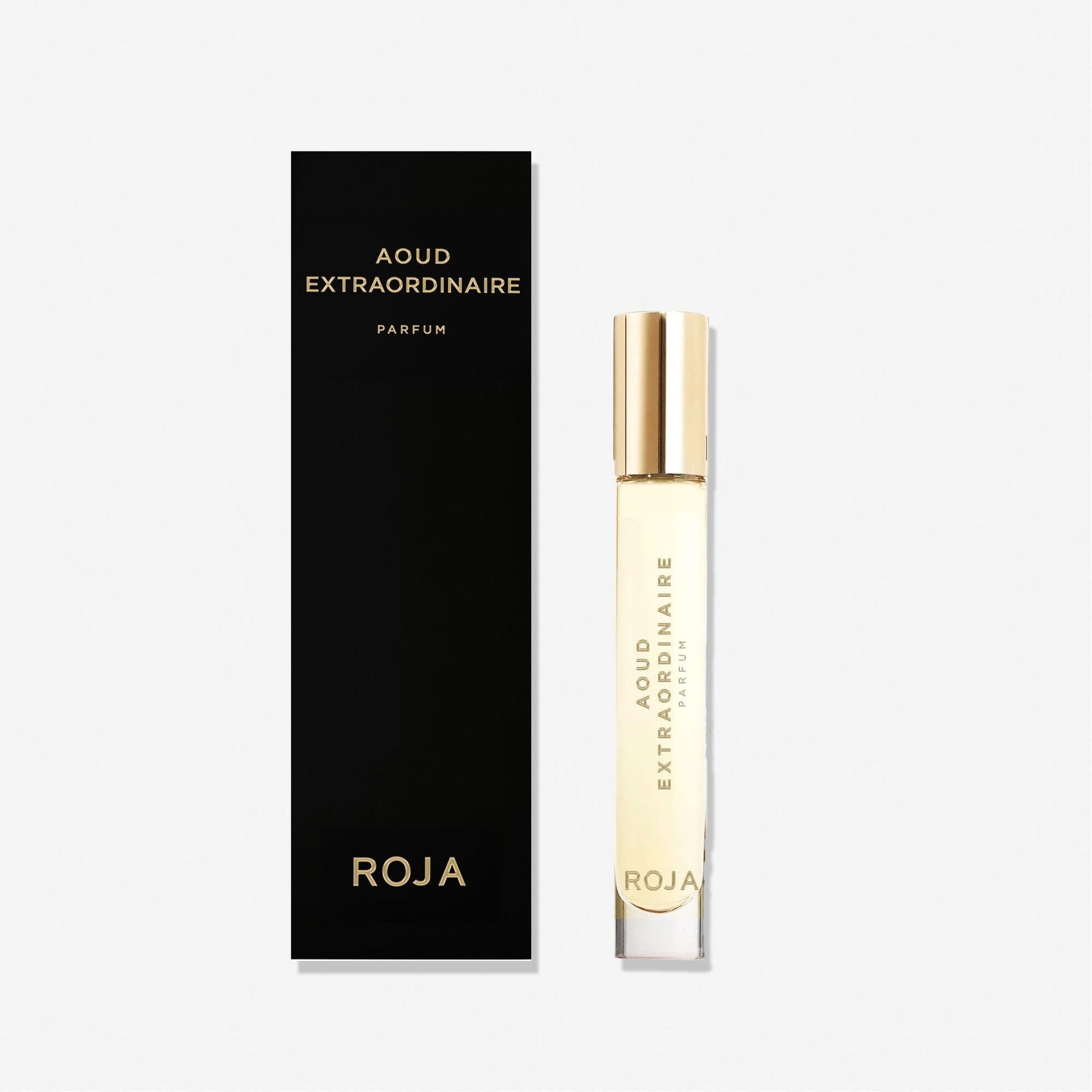 A clear perfume bottle labeled Aoud Extraordinaire by Roja Parfums with a gold cap stands next to a tall black box with gold text—perfect for gifting or adding to your cart with the 100% off BOGO Bundle from the free gift app.