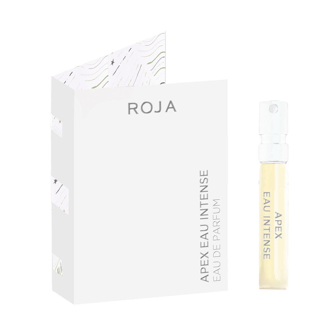A small vial of Apex Eau Intense Sample by Roja Parfums is displayed next to its white box, which has subtle line patterns. The vial features a minimalist design with text along its side.