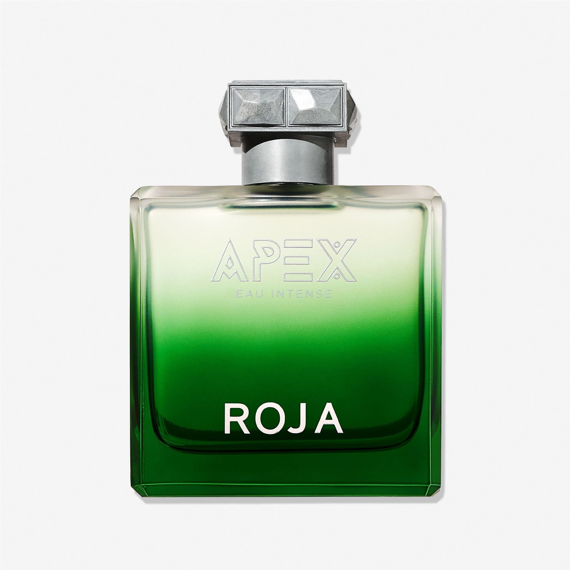 A green glass bottle of Roja Parfums Apex Eau Intense, showcasing its signature Chypré accord and adorned with a silver gem-like cap and bold white lettering, is displayed against a plain white background.