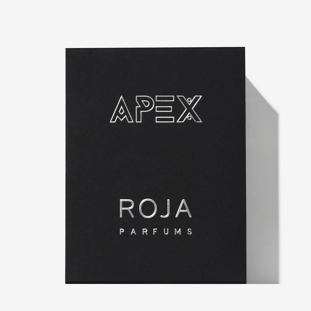 A black box labeled Apex Pour Homme in bold at the top with Roja Parfums in smaller silver letters below evokes a nature-inspired fragrance, all set against a plain white background.