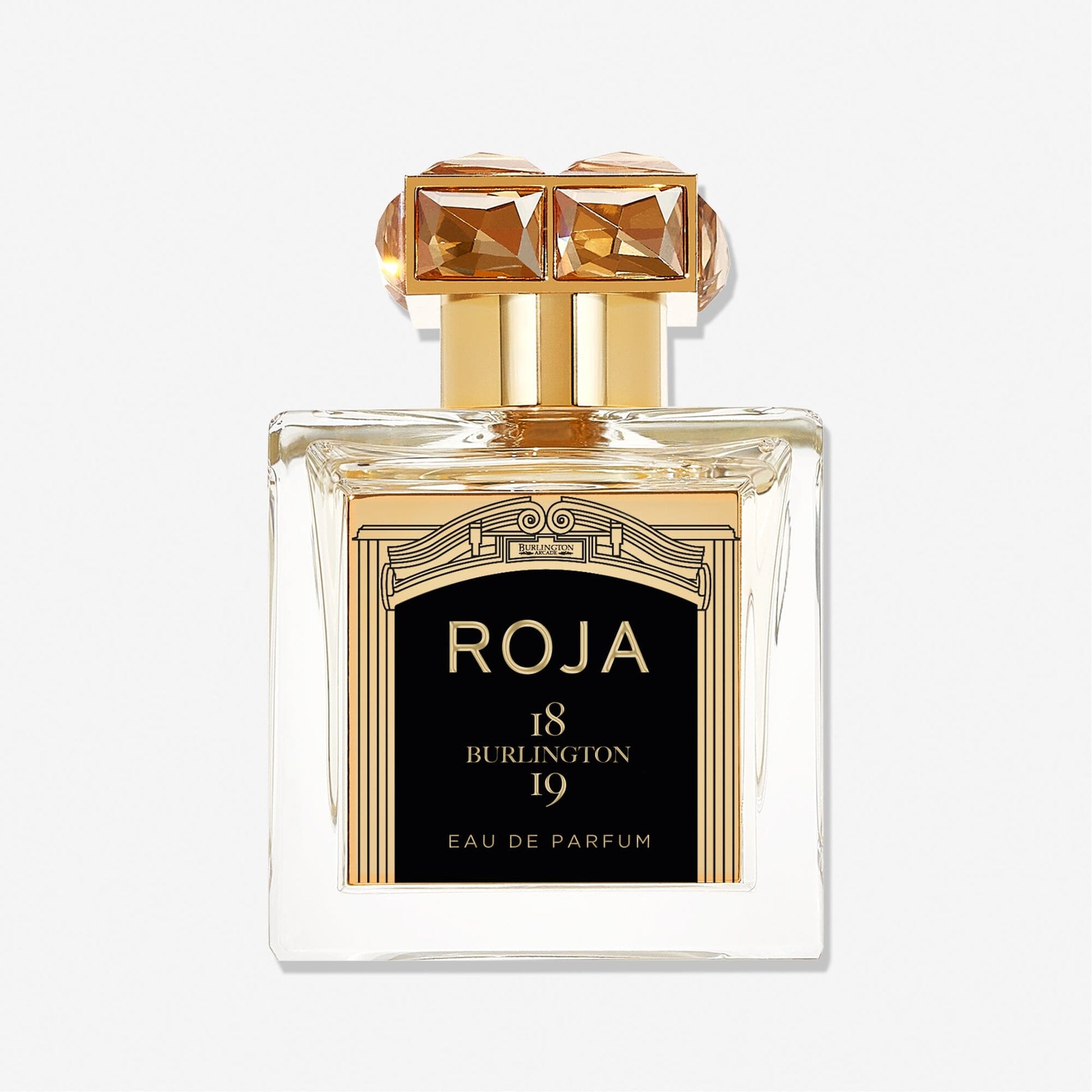 A clear glass bottle of Roja Parfums Burlington 1819 Eau de Parfum, featuring a gold and black label with a gem-like cap, set against a plain white background—evoking the elegance of Burlington Arcade.