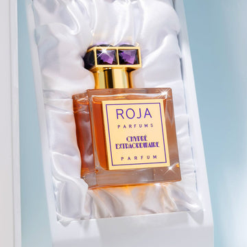 Chypré Extraordinaire by Roja Parfums, featuring a gold and purple cap, sits in a white satin-lined box and exudes a chic blend of Bergamot and Moss Notes.