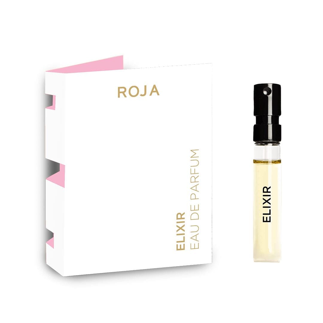 A 2ml sample vial of Roja Parfums Elixir Eau De Parfum rests by its white and gold box with a pink interior. Enjoy this free gift on BOGOS.io. The vial has a black spray cap and holds clear fragrance inside.