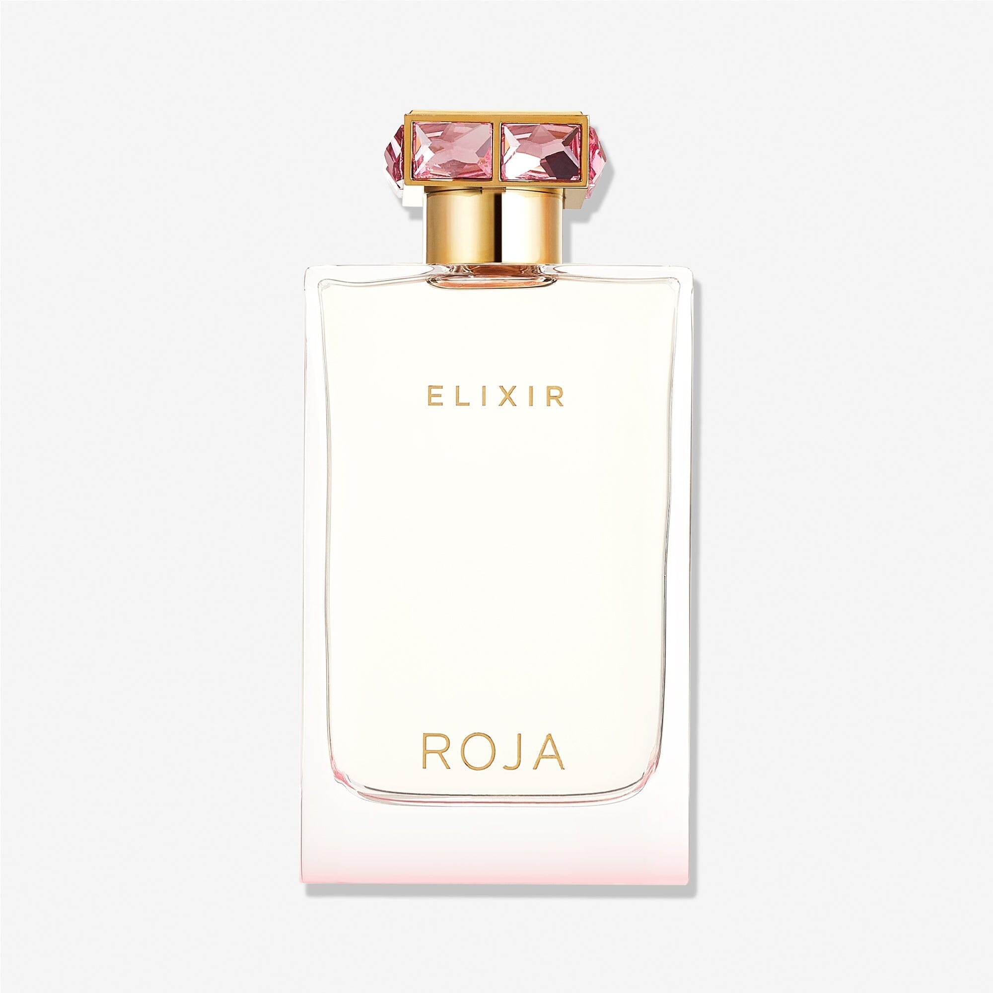 A clear perfume bottle with gold accents, labeled "Elixir Pour Femme" at the top and "Roja Parfums" at the bottom. The jewel-studded gold cap features large pink gemstones, highlighting this luxurious fragrance against a plain white background.
