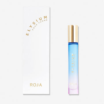 A rectangular white box labeled Elysium Pour Femme by Roja Parfums sits beside a slim perfume bottle with a gold cap, blue-to-pink gradient glass, and gold lettering—suggesting opulent fruity, floral, and musk scents on a white background.