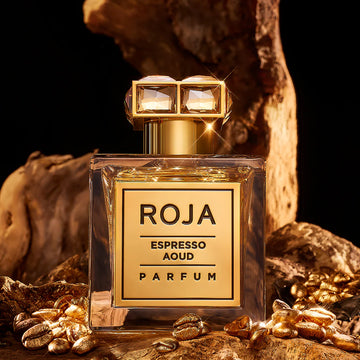 Roja Espresso Aoud parfum bottle with coffee beans on a wooden background