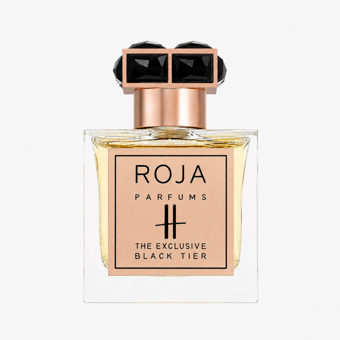 A perfume bottle from Roja Parfums, named Harrods Black Tier, showcases a gold plaque and an ornate black and gold cap, housing light amber liquid—an exquisite example of luxury fragrance.