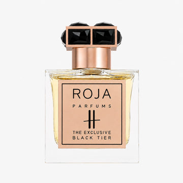 A perfume bottle from Roja Parfums, named Harrods Black Tier, showcases a gold plaque and an ornate black and gold cap, housing light amber liquid—an exquisite example of luxury fragrance.