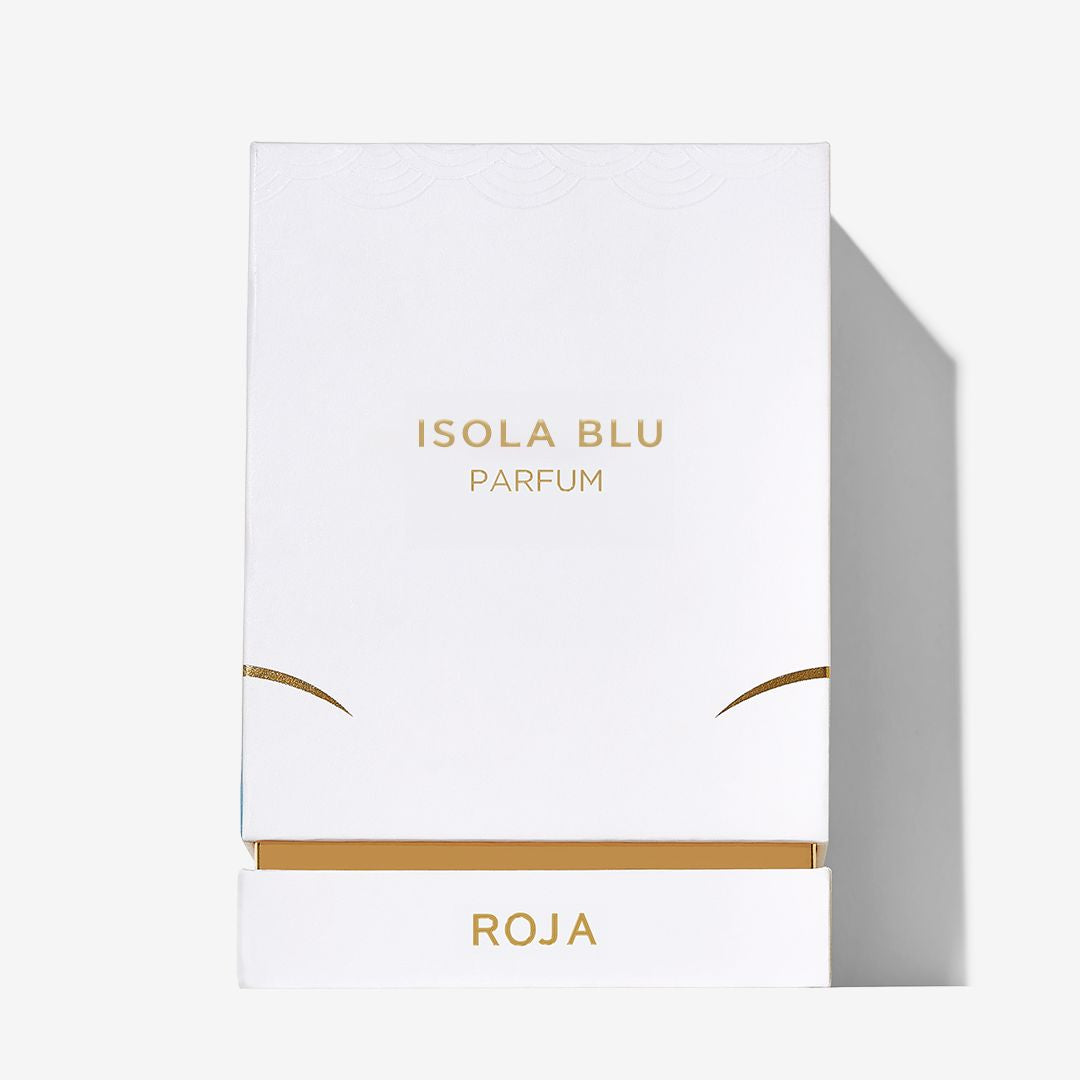 A white box labeled Isola Blu Parfum in gold text with a gold accent and Roja on a strip at the bottom casts a shadow on a plain white background, reflecting the Mediterranean-inspired luxury of Roja Parfums Isola Blu.
