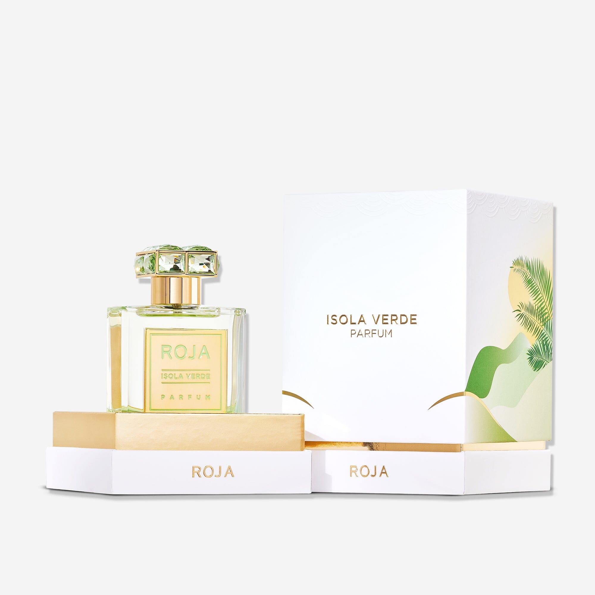 A bottle of Roja Parfums Isola Verde, featuring a decorative cap, is shown beside its open white and gold box with green and gold leaf designs and "Isola Verde Parfum" text, showcasing the luxury fragrance.