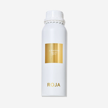 A white cylindrical bottle labeled “London” by Roja Parfums features a gold square on the front and the brand name at the bottom, reflecting London elegance, set against a plain white background.