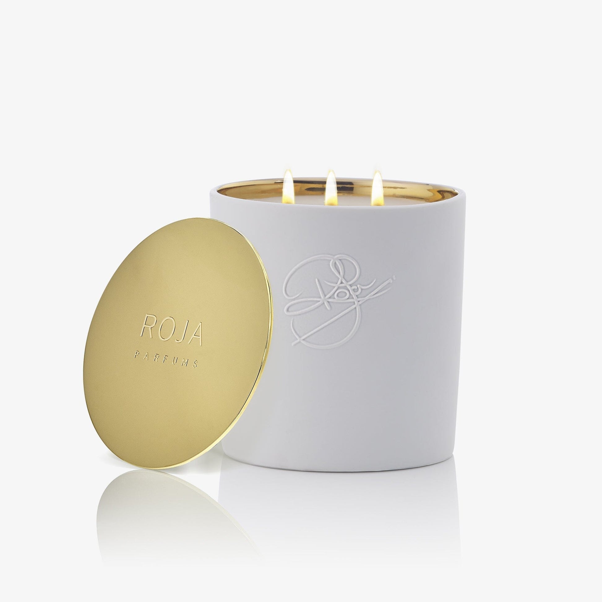 The Peony Of Luoyang candle by Roja Parfums features three flames in a glossy white, embossed container with a gold ROJA PARFUMS lid, bringing floral elegance to your space. All elements are set against a white background.