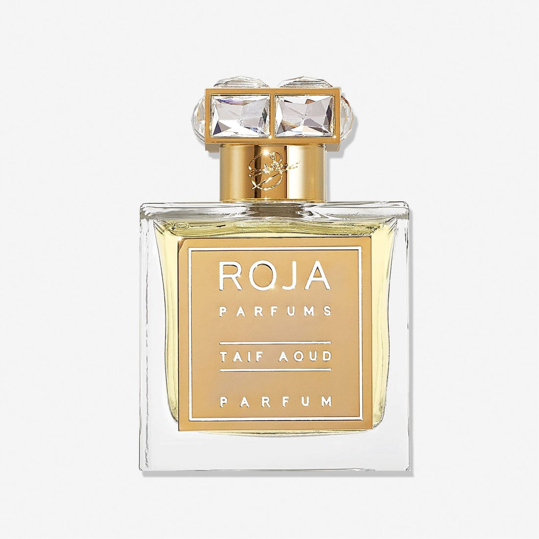 A clear glass Taif Aoud perfume bottle by Roja Parfums features a gold label and an ornate gold-and-crystal cap, capturing the essence of Arabian Rose, displayed on a white background.