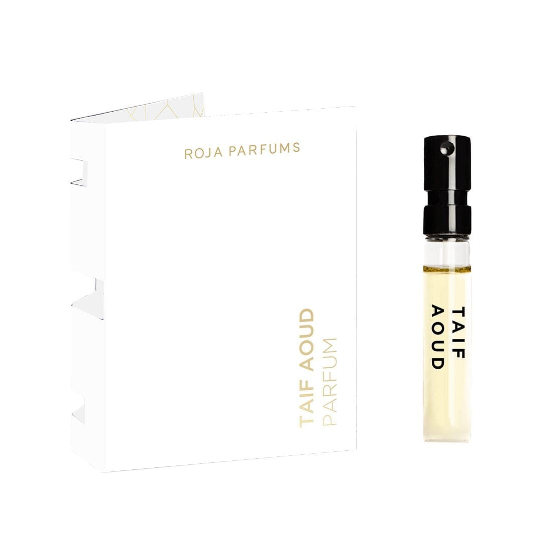 A Taif Aoud Parfum Sample (Gift) by Roja Parfums sits beside its white-gold box, featuring minimalist text and a clear vial with a black spray cap—a 100% off free gift from BOGOS.io.