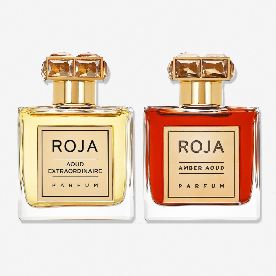 The Aoud Layering Gift Set by Roja Parfums features two luxurious bottles—Aoud Extraordinaire Parfum (light yellow) and Amber Aoud Parfum—perfect for oud lovers seeking an exquisite fragrance layering experience.