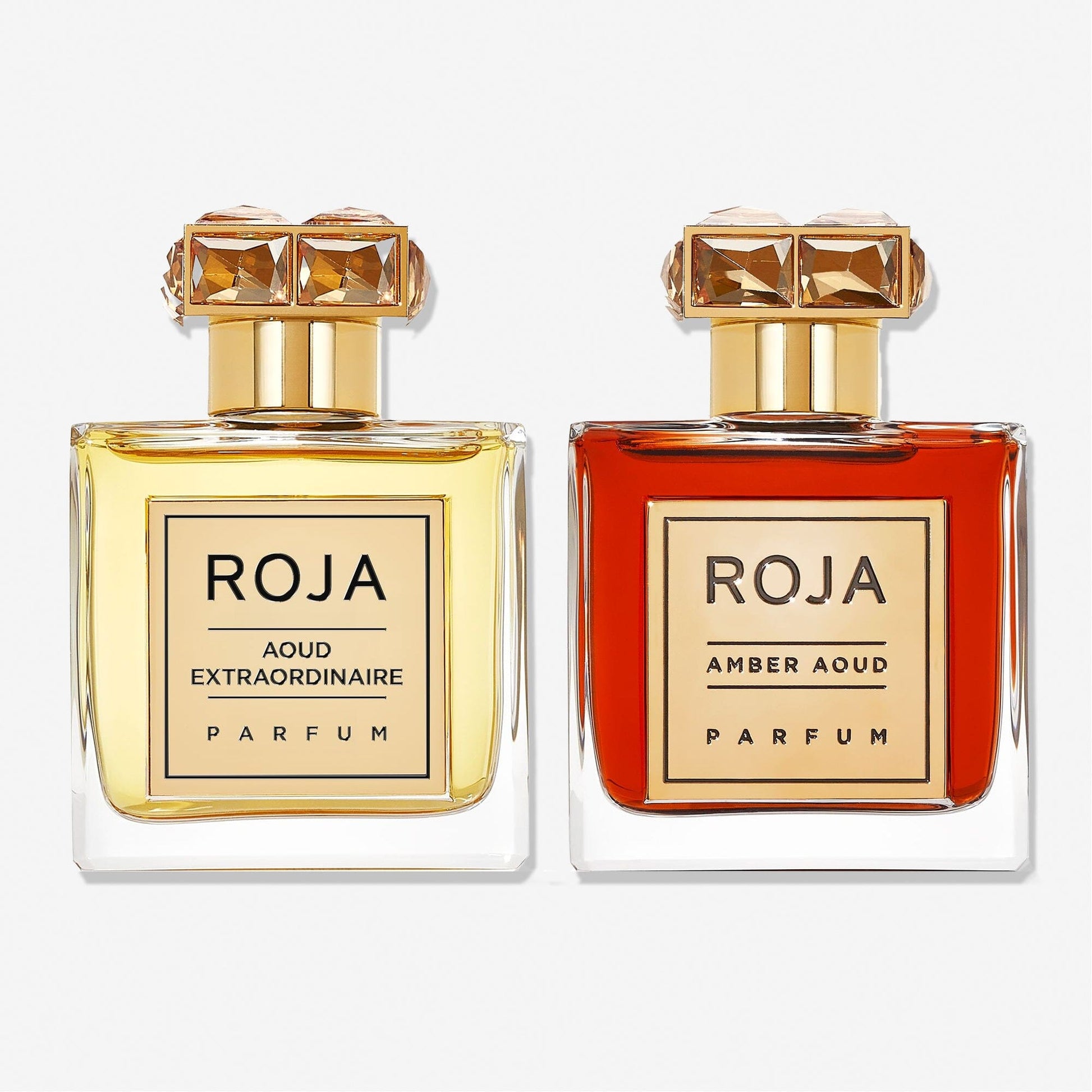 The Aoud Layering Gift Set by Roja Parfums features two luxurious bottles—Aoud Extraordinaire Parfum (light yellow) and Amber Aoud Parfum—perfect for oud lovers seeking an exquisite fragrance layering experience.
