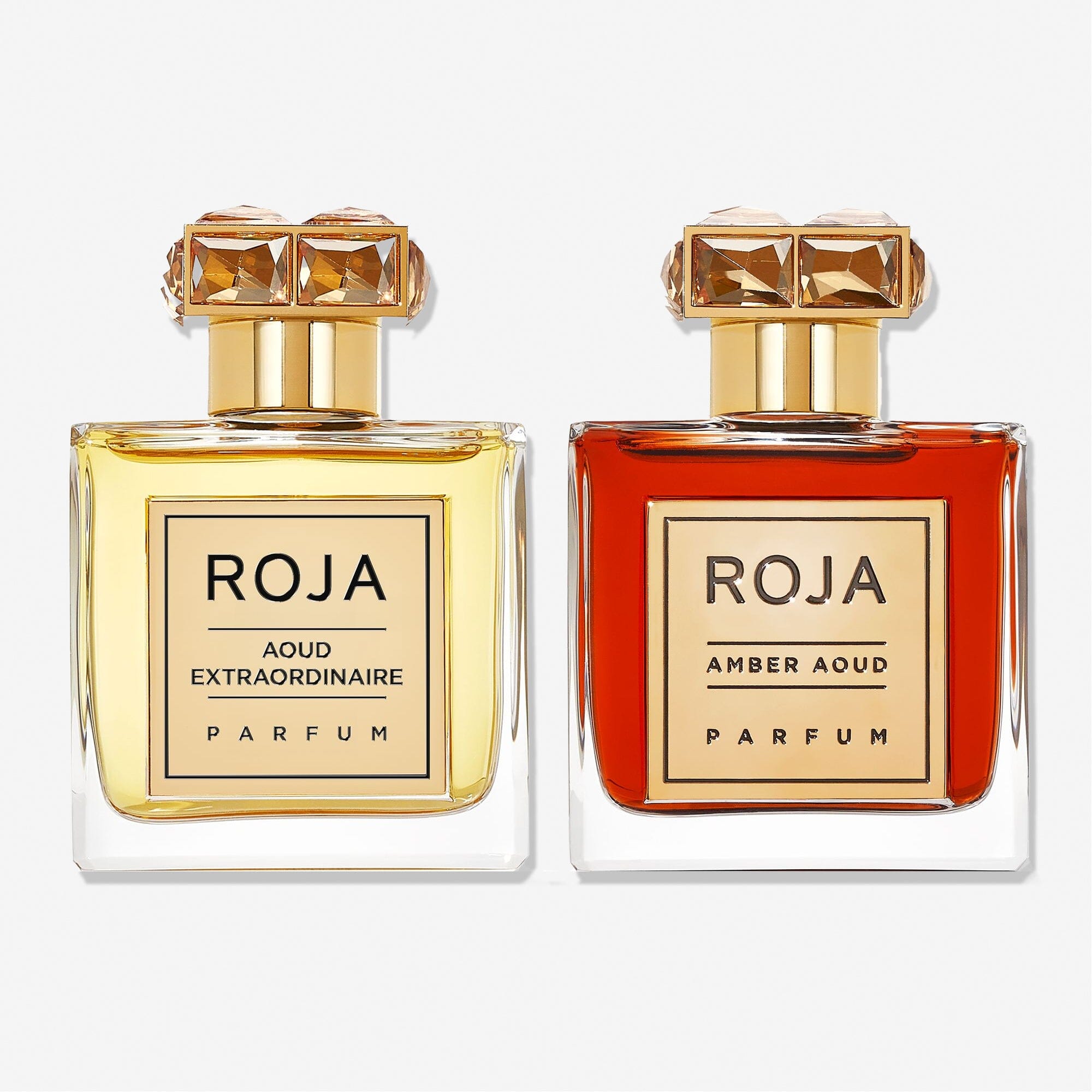 The Aoud Layering Gift Set by Roja Parfums features two luxurious bottles—Aoud Extraordinaire Parfum (light yellow) and Amber Aoud Parfum—perfect for oud lovers seeking an exquisite fragrance layering experience.