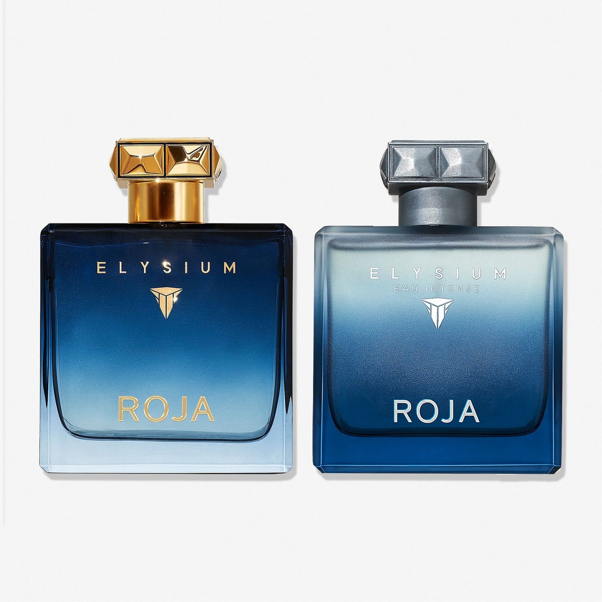 Two square Roja Parfums Elysium Gift Set bottles sit against a white background. The left bottle has a gold cap and label, the right features silver accents. Both elegantly fade from dark blue to clear—a true Art of Layering masterpiece.