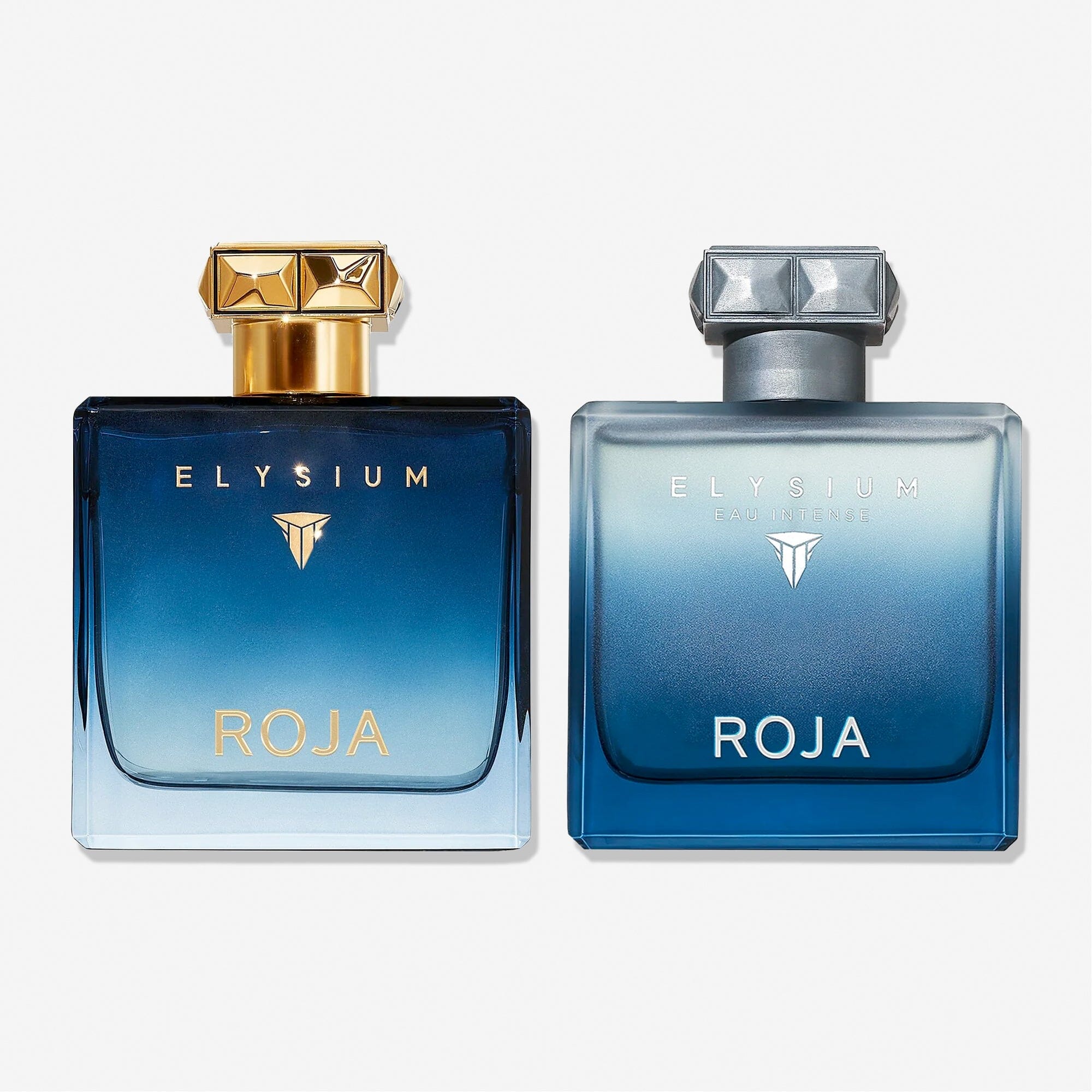 Two square perfume bottles from Roja Parfums’ The Elysium Gift Set feature gradient blue glass—one with gold cap and lettering, the other silver. Ideal for fragrance layering, they stand side by side on a white background.