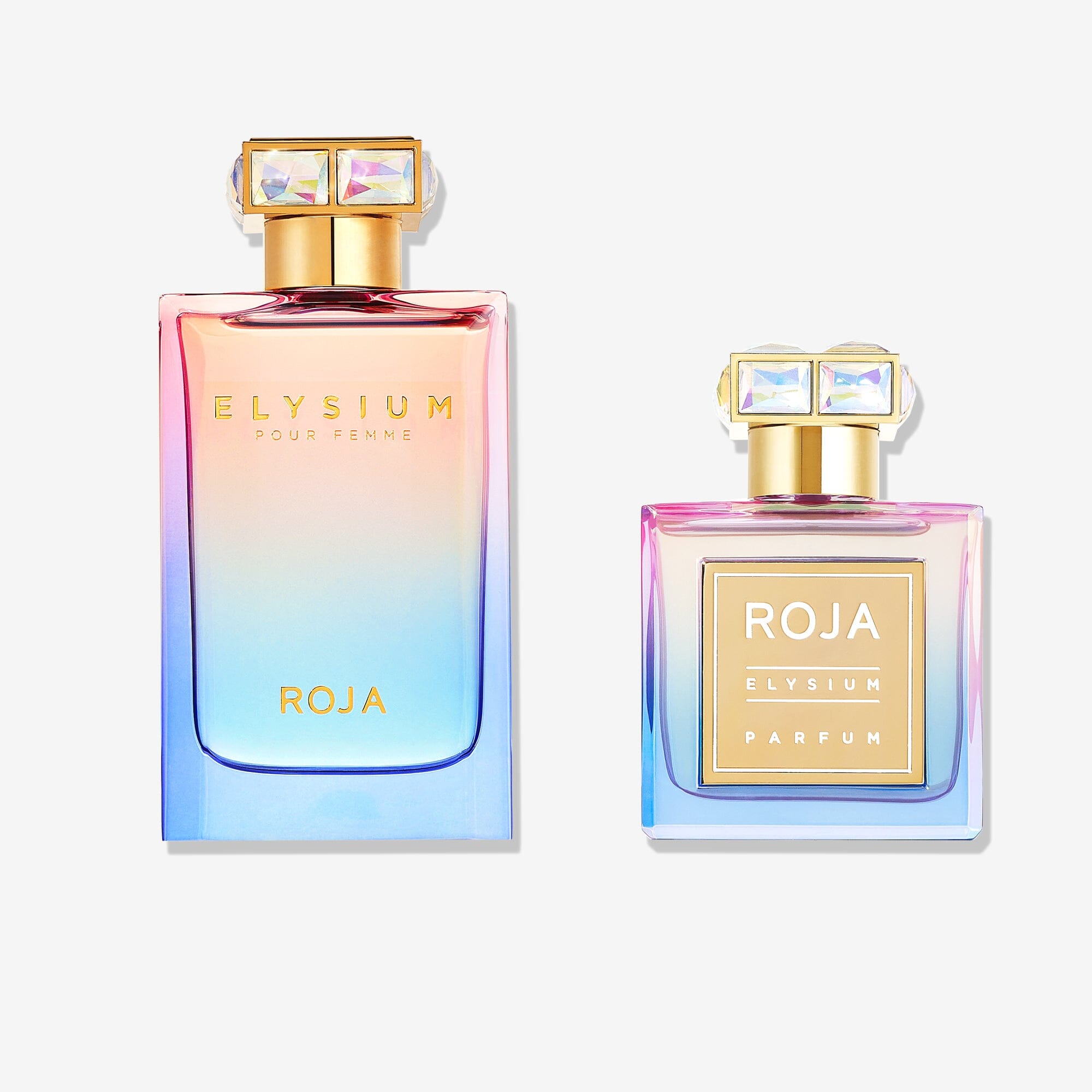 The Elysium Pour Femme Gift Set by ROJA London features two perfume bottles with gold caps and iridescent pink-to-blue labels, the taller labeled Elysium Pour Femme and the shorter labeled Elysium Parfum.