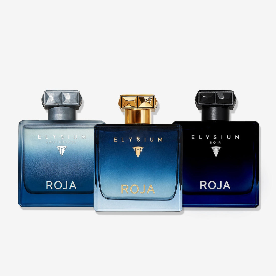 Three bottles from The Elysium Trio by ROJA London are displayed side by side with blue-toned designs and metallic caps—ideal for discovering Art Of Layering and enhancing your fragrance collection.