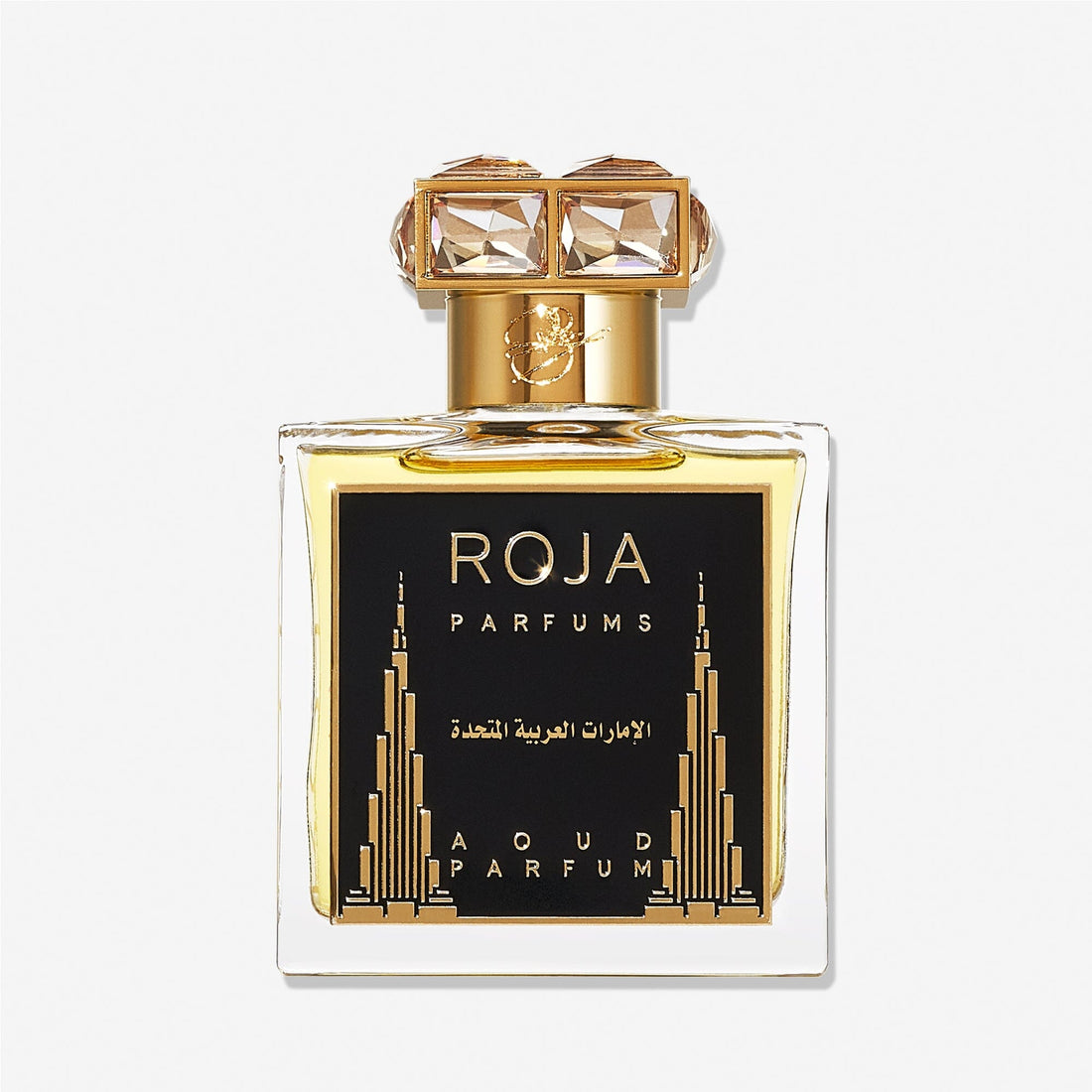 A bottle of Roja Parfums United Arab Emirates with a gold cap and black label, adorned with gold Middle Eastern designs and Arabic script, offers an intoxicating blend of oud and pink pepper.